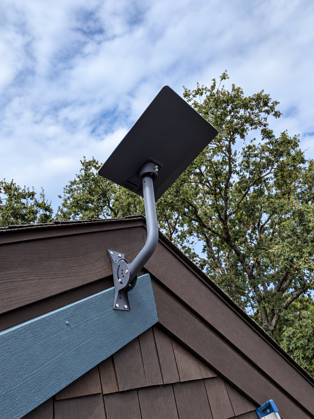 Recent Starlink dish and wall mount installed on a building