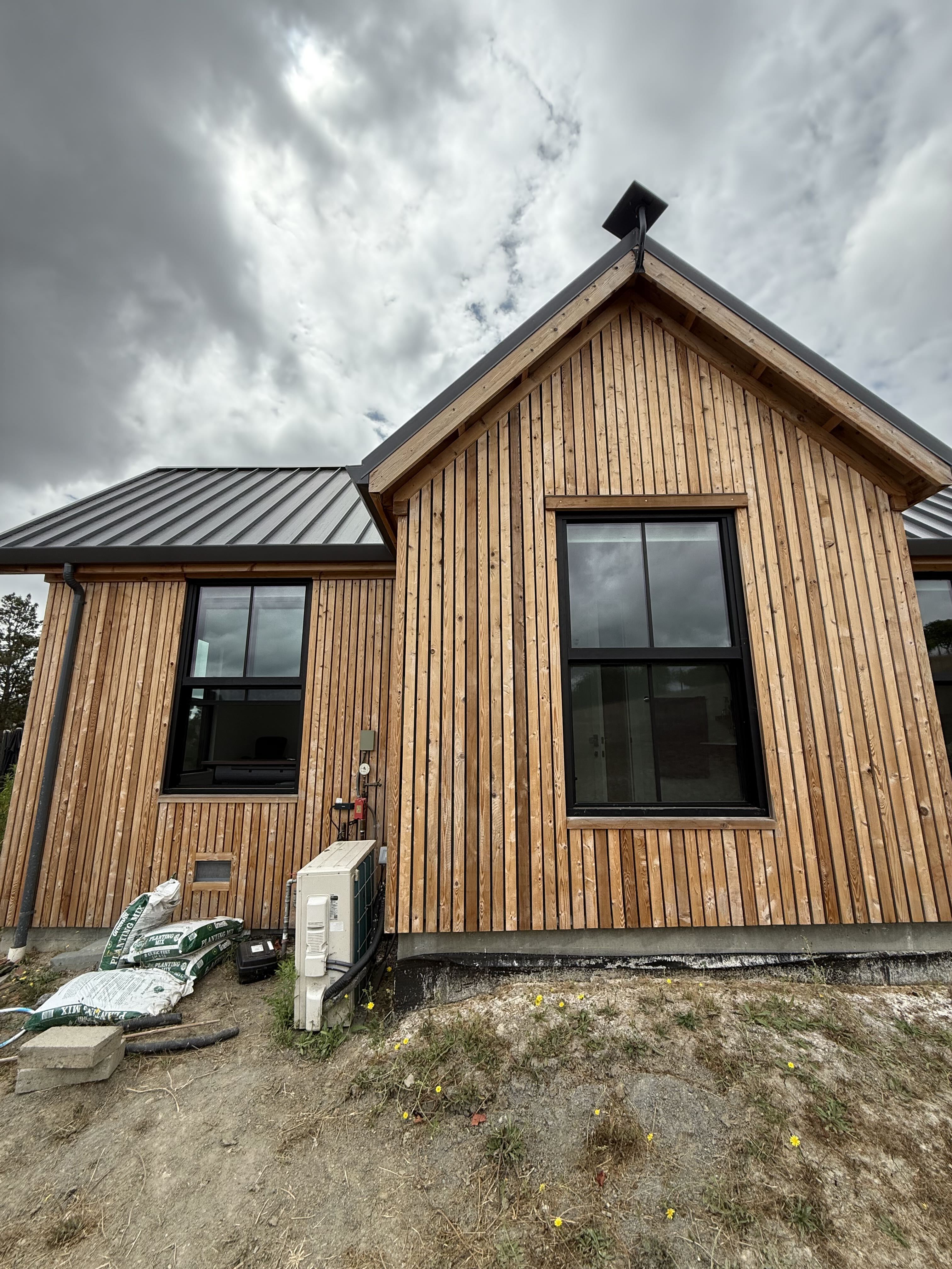 Starlink dish mounted above the gable of a wood-sided home